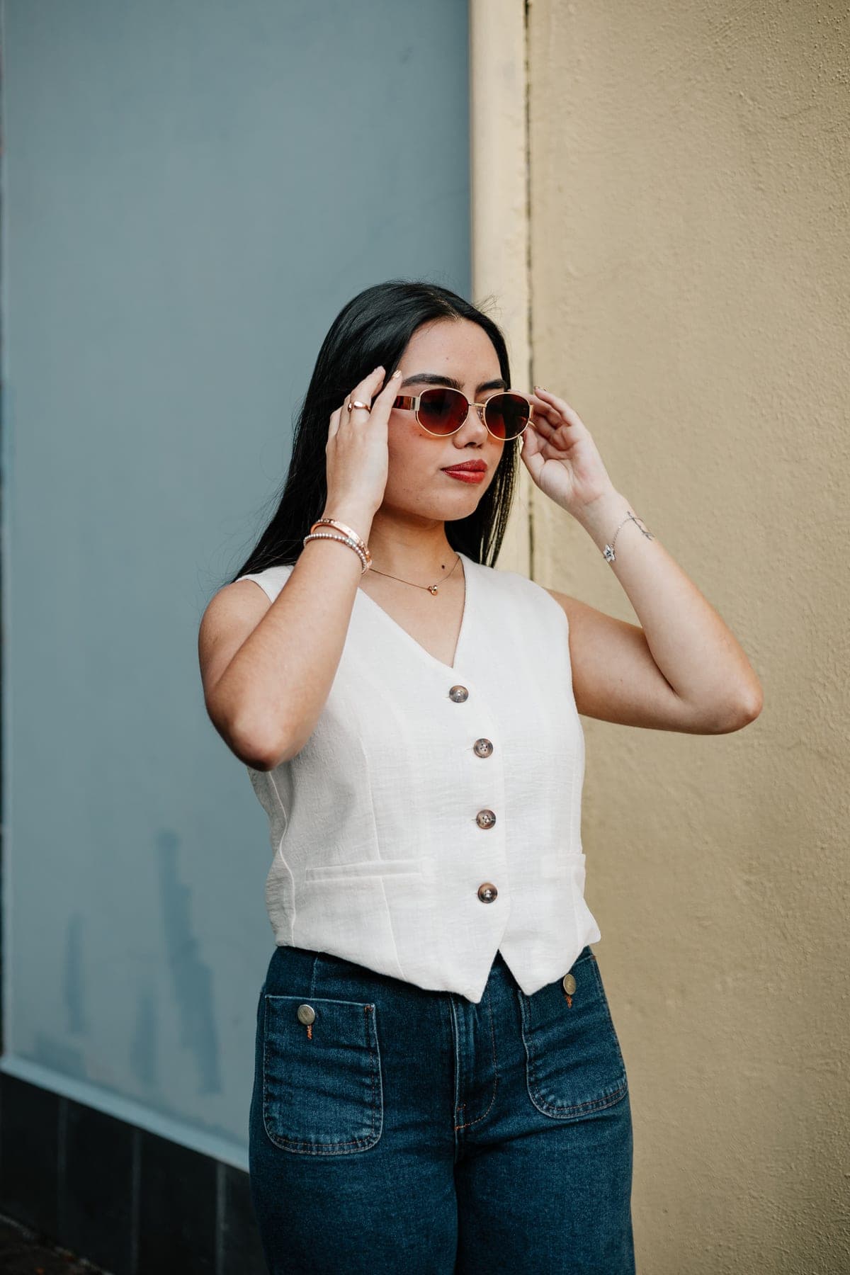 A person wearing acetate sunglasses in soft natural daylight
